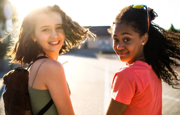Nastolatki dziewczyny przyjaciele spacery na świeżym powietrzu w mieście, patrząc w kamery. — Zdjęcie stockowe