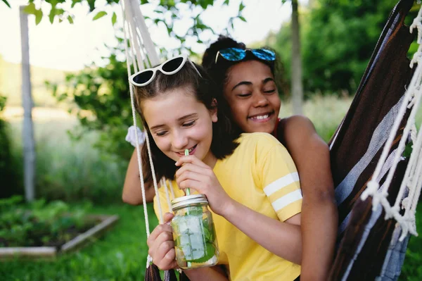 Front view of young teenager girls friends outdoors in garden, having fun. — Stock Photo, Image