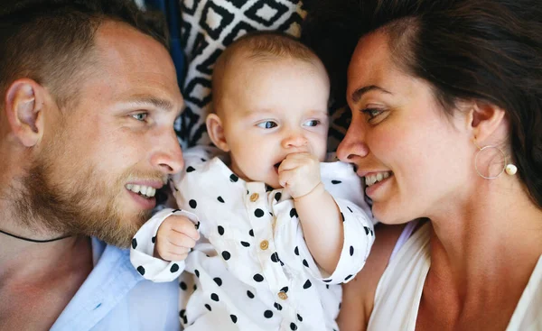 Bovenaanzicht van jong paar met dochtertje liggend op de vloer. — Stockfoto