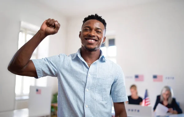 Happy african-american man voter looking at camera in the polling place, usa elections. — Stock Photo, Image