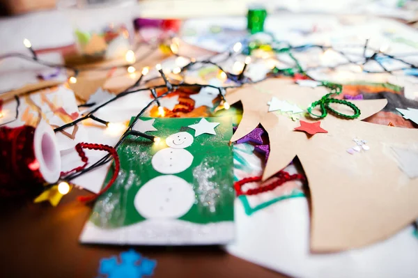 Childrens paintings and Christmas paper art and craft on table. — Stock Photo, Image