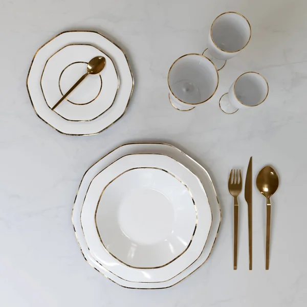 A beautiful set of dishes with a gold pattern. Plates, glasses, spoons, fork, knife on the table. 3D illustration.