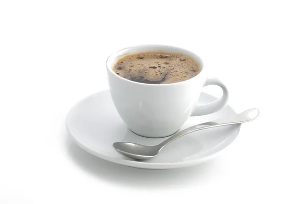 Taza de café blanco y platillo y cuchara de café negro aislado en un — Foto de Stock