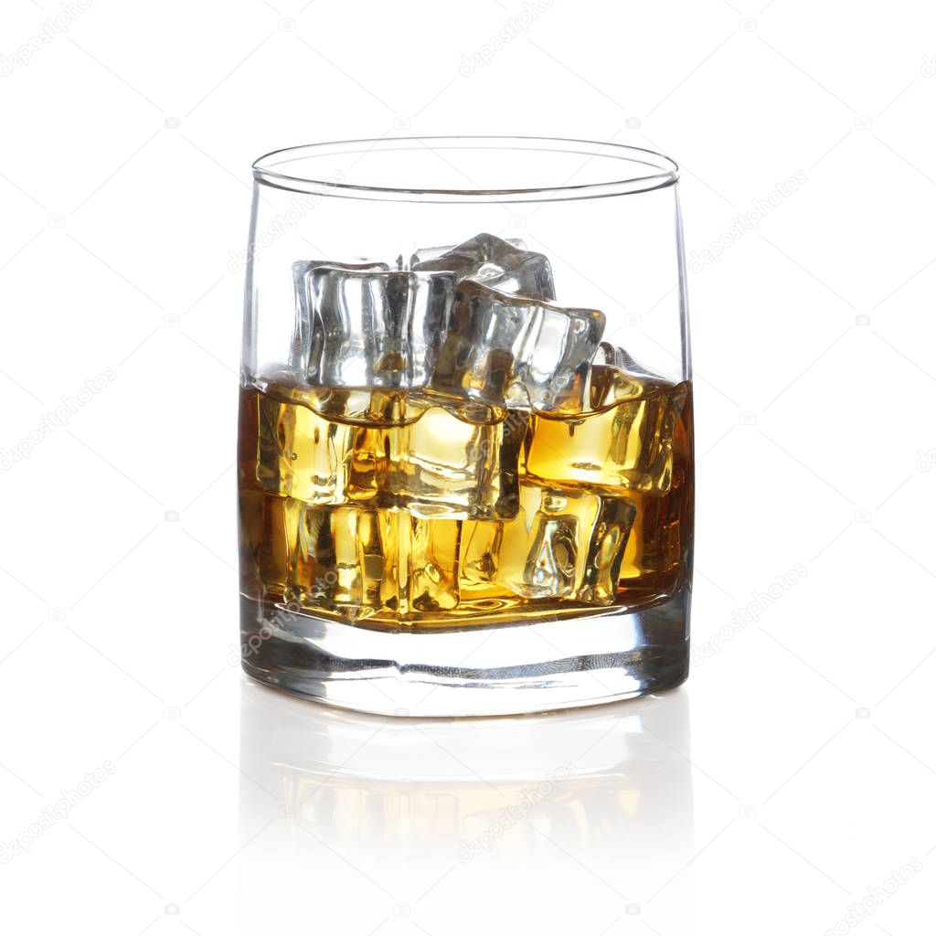 Tumbler of Scotch with ice rocks isolated on white