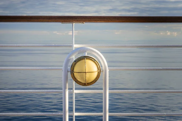 Nautical white outdoor deck lamp with brass metal fitting aboard cruise ship. — Stock Photo, Image
