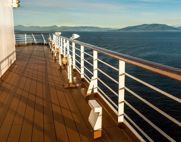 Cruise ship Port deck and railing in late afternoon, Inside Passage, BC, Canada. — Stock Photo, Image
