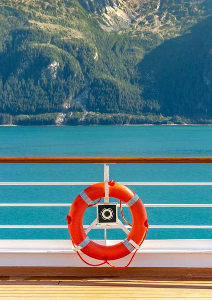 Bright orange life preserver in white metal holder aboard ship, Alaska, USA. — Stock Photo, Image