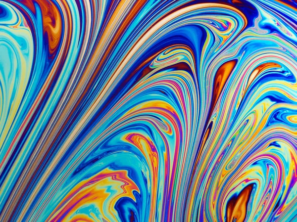 Colourful psychedelic soap bubble refractions pattern macro.