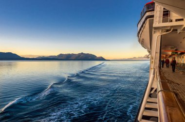 September 14, 2018 - Inside Passage, AK: Cruise passengers exercising at sunrise clipart