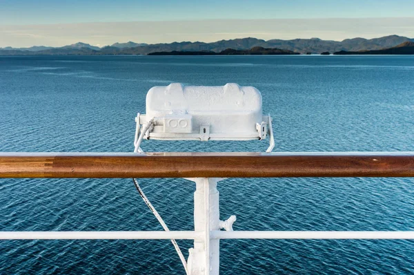 White metal exterior light fixture on railing of cruise ship, Alaska Inside Passage route. — Stock Photo, Image