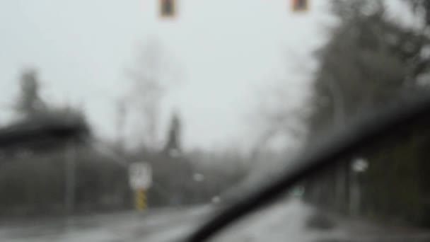 Driving in rain, out of focus background and headlights, dreary day, handheld. — Stock Video