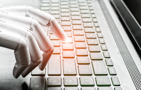 Robot hand pressing computer keyboard enter