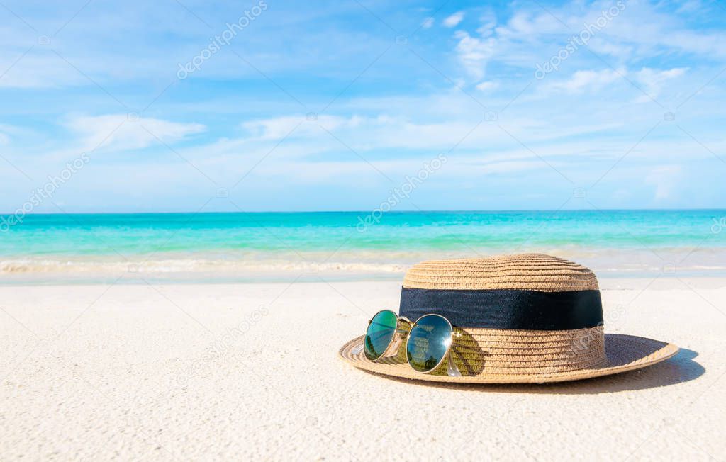 Hats and glasses placed on the beach and sea have a holiday summer relaxing and travel bright sky koh lipe thailand