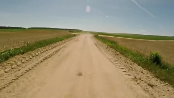 Riding on a rural road. Dust off the road. Fast driving. 57. — Stock Video