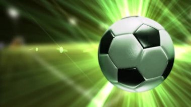 Bir futbol topu ile arka plan. Parlak yeşil ışınları ile Futbol topu.