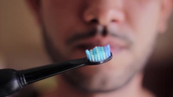 Young Man Looking Electric Toothbrush — Stock Video