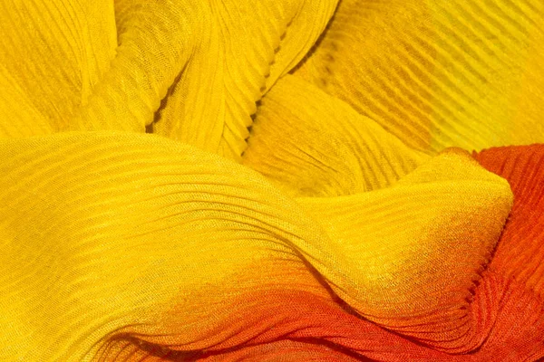 Yellow-orange corrugated fabric background.Yellow-orange corrugated fabric texture.