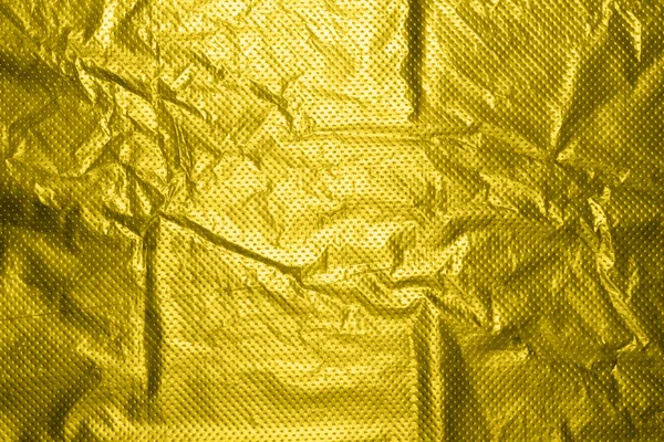 Golden plastic film.Gold plastic background.The texture of the package.