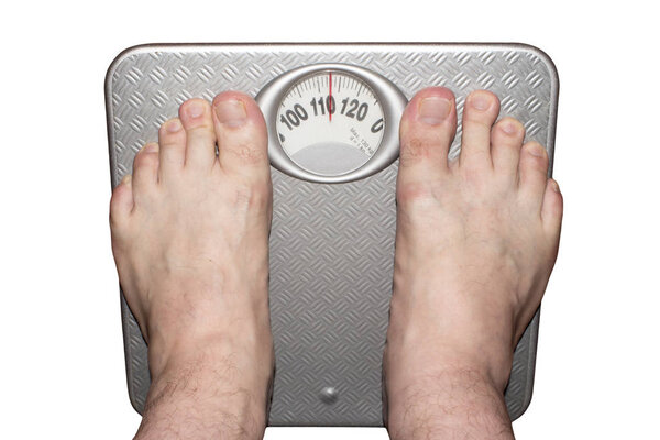 Weighing heavy man on floor scales barefoot.