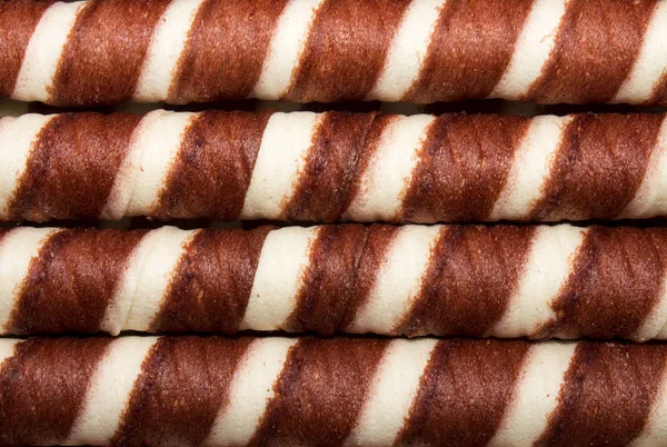 Wafer rolls with chocolate filling.Background of wafer tubules with the chocolate.