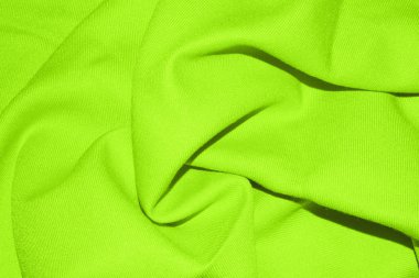 Yeşil kumaş dokusu kıvrımları ile. Işık yeşil kumaş arka plan ile pileler.