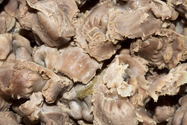Boiled chicken stomachs.Background with peeled boiled chicken stomachs.