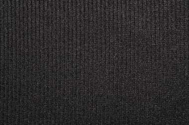 Doku siyah sıkı dokuma halı. Halının karanlık arka planı. Siyah naylon kumaş.