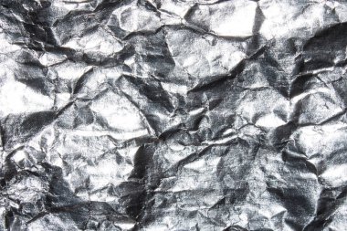 Buruşuk folyo dokusu. Buruşmuş gümüş folyo arka plan.