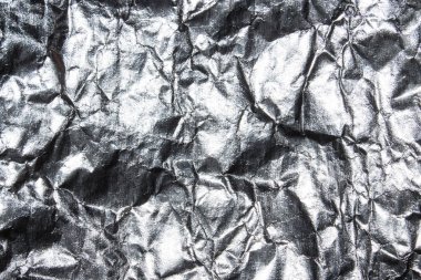 Buruşuk folyo dokusu. Buruşmuş gümüş folyo arka plan.