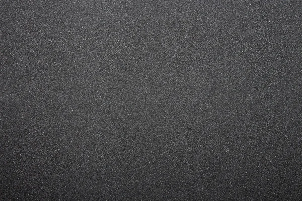 Black sandpaper texture.Dark grey rough background.