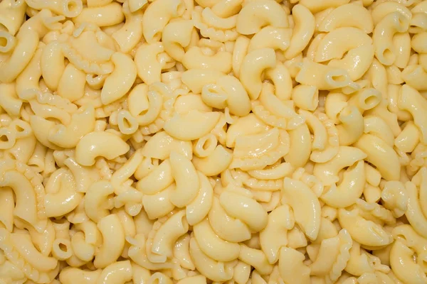Boiled pasta.Macaroni cones.Background of cooked pasta.