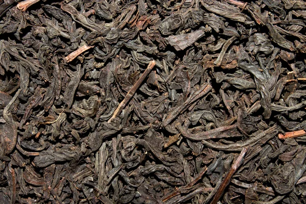 Black tea brewing.Background of dried black tea leaves.