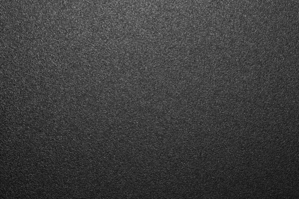 Texture of black matte plastic.Black and white matte background.The background is black rough plastic.