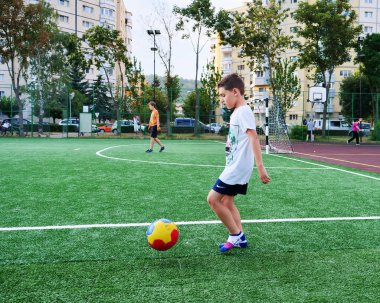 Kaloşvar, Romanya-15 Ağustos 2018: Genç çocuk çalış çorap genel futbol sahası üzerinde bir top ile