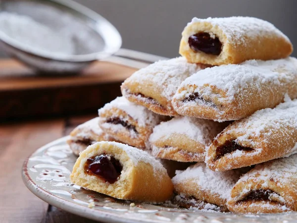 Biscuit Rolls Filled Jam Powdered Sugar Top Plate Wooden Table — Stock Photo, Image