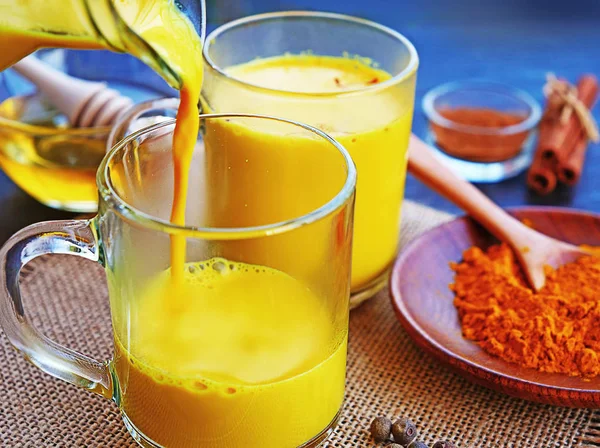 Golden Turmeric Milk Poured Glasses Warm Turmeric Latte Ingredients Cinnamon — Stock Photo, Image