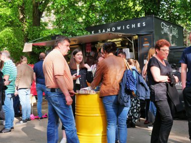 Bazı peole sokak gıda festivalinde davul masalarında yemek