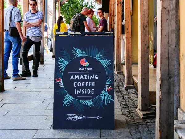 Outdoor sidewalk sign inviting people to a coffee — Stock Photo, Image