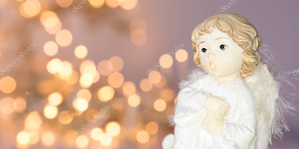 angel in-front of sparkling blurry lights background