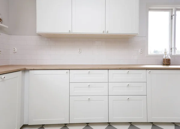 detail of a clean contemporary interior of a white kitchen counter top