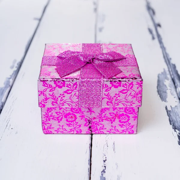 One pink gift Box on vintage wooden
