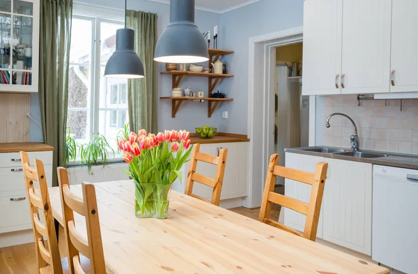 kitchen with flowers and chairs on background