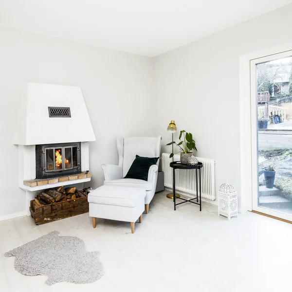 foreground fancy living room with lit fire in fireplace in the background