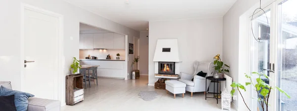 foreground fancy living room with lit fire in fireplace in the background