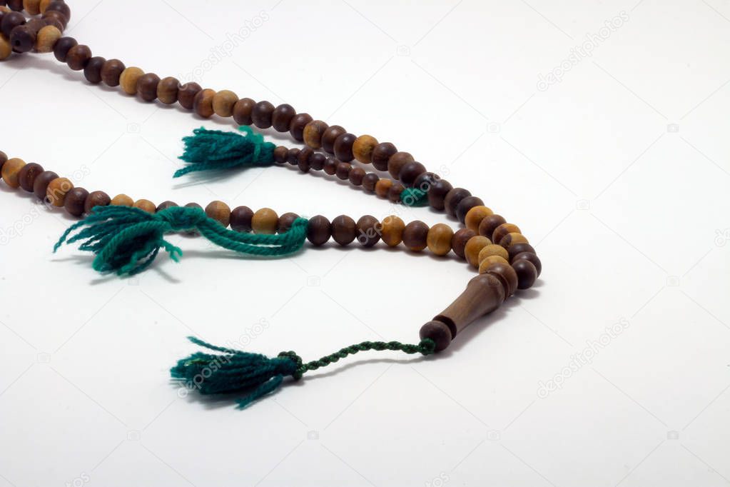 Religious rosary on white ground