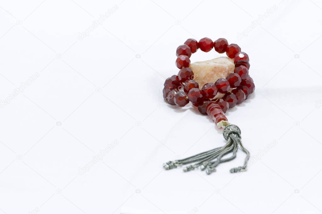Religious rosary on white ground