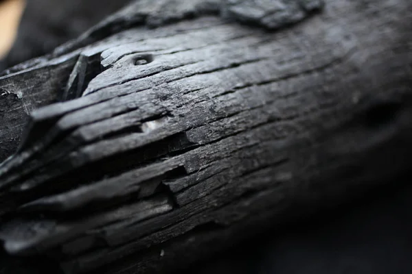 Burned wood. black wood from the fire. Rings on wood. Ash. Wood burnt on coal