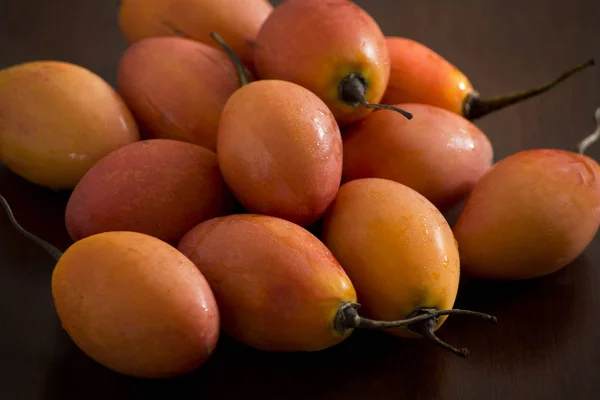 Delicious tamarillo fruits. Egg-shaped edible tropical exotic fruit from the Solanum betaceum plant, popular in South America. Also named tree tomato.