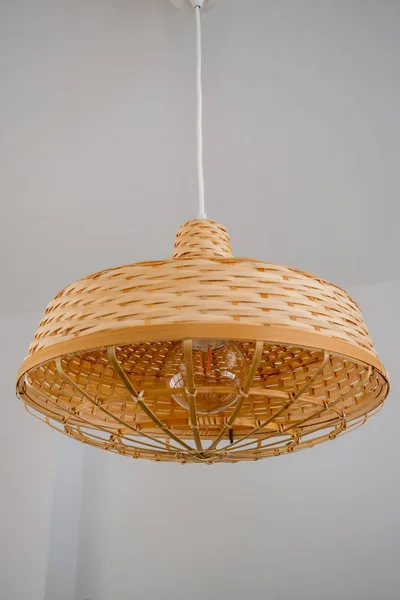 Wooden lamp hanging from ceiling