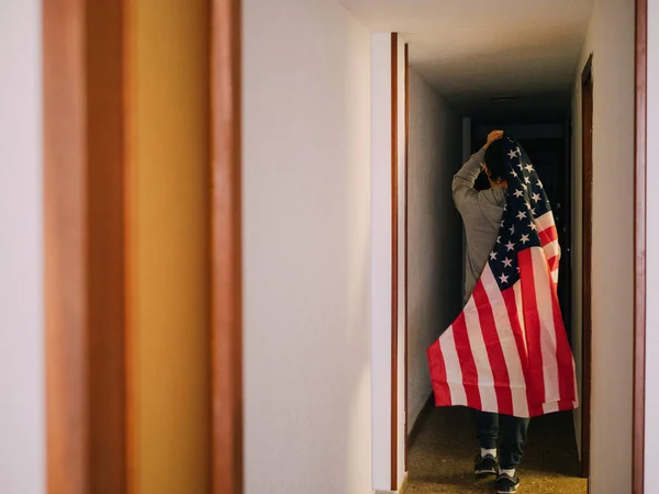 Man covering himself with the United States flag